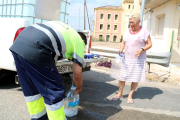 Un operari de la Brigada Municipal de Móra la Nova omple les garrafes d'una veïna.