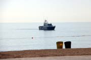 Un vaixell de la Guàrdia Civil a la zona de la platja de Sant Sebastià on s'ha trobat l'artefacte explosiu.