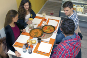 Una comensales a punto de degustar unas sartenes|paellas de arrços.