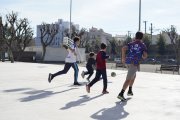 Diversos nens jugant en un pati d'una escola oberta els dissabtes.