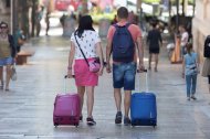 Imagen de archivo de turistas con maletas.