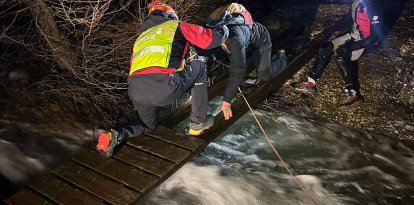 Imatge dels Bombers ajudant a la parella a creuar el pont a Margalef