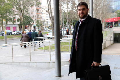 El abogado Anton Verdeny, en las puertas de los juzgados de Reus, con sus clientes, de espalda, en el fondo de la imagen.