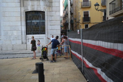 Un grup de vianants es repensa creuar el carrer Sant Domènec.