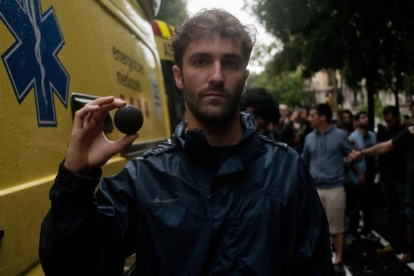 Un joven muestra una pelota de goma después de una carga policial a BArcelona.