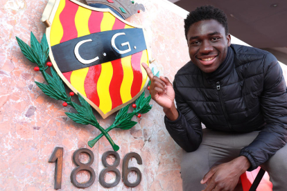 Jean Marie Dongou, al costat de l'escut del Nàstic que hi ha a la llotja del Nou Estadi. El futbolista està completament preparat per començar a ser titular.