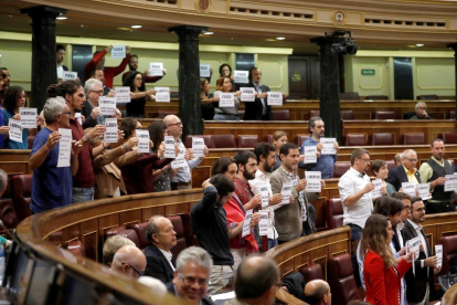 Los diputados de Podem, ERC y PDeCAT mostrando carteles de apoyo|soporte a Cuixart y Sànchez al Congreso.
