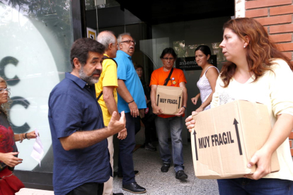 Voluntarios de l'ANC y su presidente, Jordi Sánchez, vacían la sede de la entidad de todo el material.