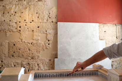 Muñoz mostra sobre una maqueta el lloc exacte del mur i, al darrere, carreus i plaques de marbre.