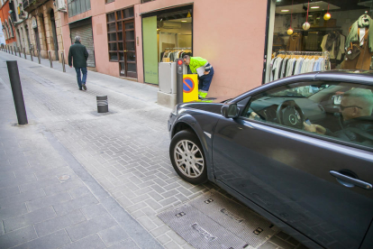 Manuel Salines, usuario de una plaza de parking, marca el número de teléfono para bajar el pilón.