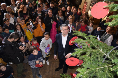 L'alcalde ha ajudat els infants a col·locar els seus desitjos a l'arbre.