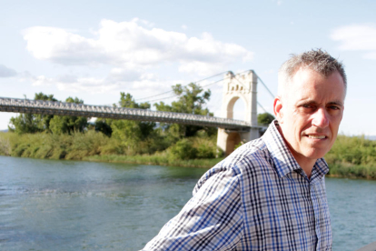 El alcalde de Amposta, Adam Tomàs, con el puente colgante y el río Ebro de fondo.