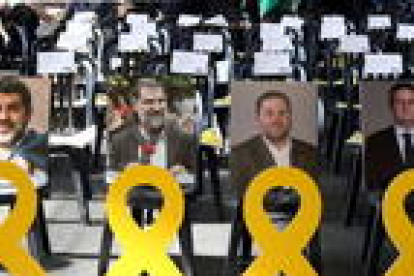 Una fotografia i un llaç groc dels empresonats Jordi Sánchez, Jordi Cuixart, Oriol Junqueras i Joaquim Forn a la primera fila de l'Assemblea General Ordinària de l'ANC.