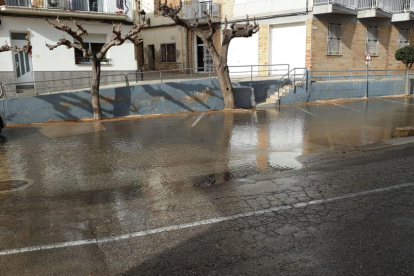 Pla general d'un carrer de l'Ampolla inundat per la baixada dels barrancs arran la reparació de la canonada.