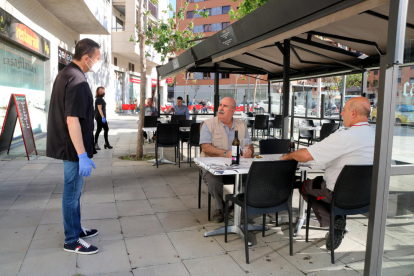 El propietario del bar restaurando Casa Matías de Tarragona hablando con los primeros clientes que tiene en la terrasa con motivo del paso a la fase 1.