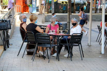 Imatge d'unes dones assegudes en una terrassa de l'avinguda del Torrent Gornal de l'Hospitalet de Llobregat.