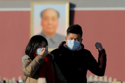 Dos chinos con mascarilla para evitar el contagio del coronavirus originado en Wuhan