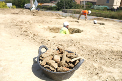 En primer pla, un cabàs amb ceràmiques recuperades a les sitges ibèriques de Serinyà