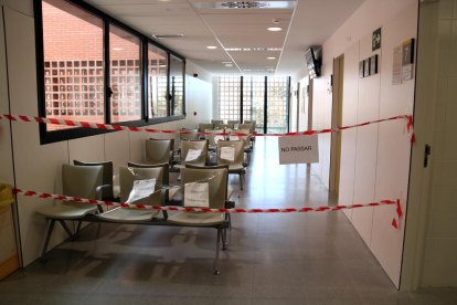 Una sala d'espera del CAP d'Amposta amb els seients precintats i l'accés prohibit.