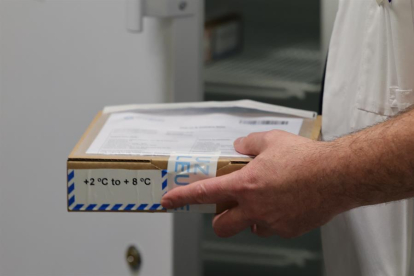 Un sanitari recull un paquet de vacunes anti-covid-19, distribuït per la farmacèutica Pfizer-BioNTech a Leuven.