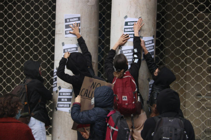 Estudiants d'arts en viu encartellen la façana del Teatre Coliseum durant la manifestació per la vaga convocada contra els casos d'abusos de poder i assetjament denunciats a l'IT.