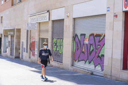 El tramo de la calle Rovira i Virgili que va del cementerio hasta la avenida Catalunya tiene las persianas y las paredes llenas de pintadas.