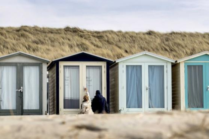 Un par de turistas en una de las casetas de playa en los Países Bajos.