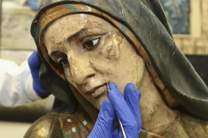 Detalle de la cara de la virgen, donde se acumulaban capas de pinturas.