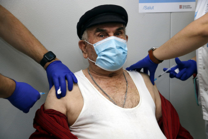 Un senyor major de 70 anys és vacunat de forma simultània de la grip i de la tercera dosi de la covid.