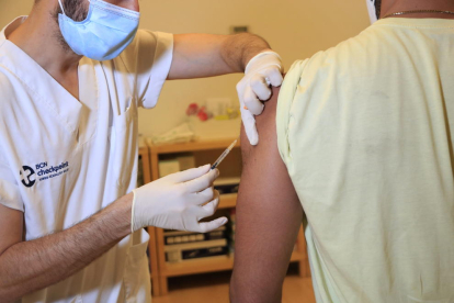 Un home rep la vacuna de la verola del mico al BCN Checkpoint.