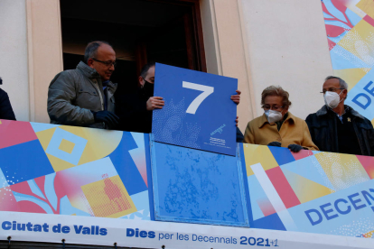 Els membres de l'Agrupació de Confraries i Germandats Setmana Santa a Valls canvien el marcador de les Decennals.