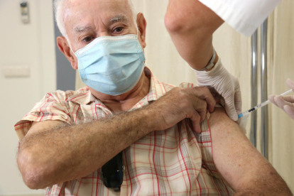 Un hombre se vacuna con doble dosis de gripe y covid en el CAP de Llefià.
