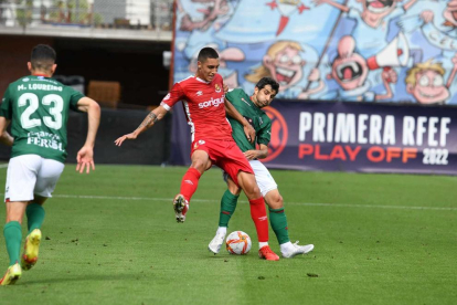 Pablo Fernández protegeix la pilota davant d'un defensa del Racing de Ferrol.