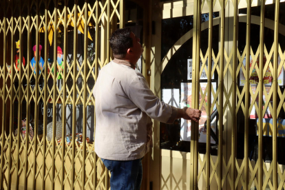 El president del Gremi de forners de Reus i el Baix Camp, Ramón de la Fuente, tancant la porta del seu negoci.