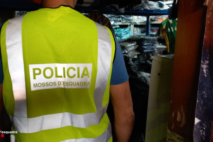 Un agente de los Mossos d'Esquadra entrando en la tienda ilegal de Reus.