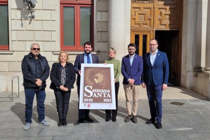 Presentació del cartell amb membres de l’Agrupació d’Associacions de Setmana Santa de Reus i la regidora Noemí Llauradó.