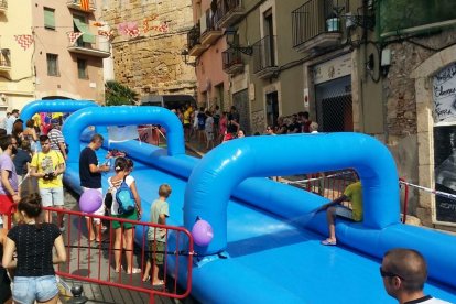 Un tobogan d'aigua de la Jove per lliscar per la Baixada de la Peixateria