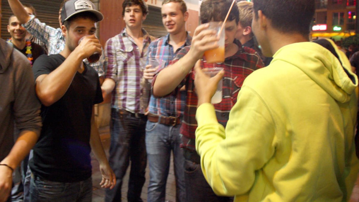 Imatge d'arxiu de joves bevent al carrer.