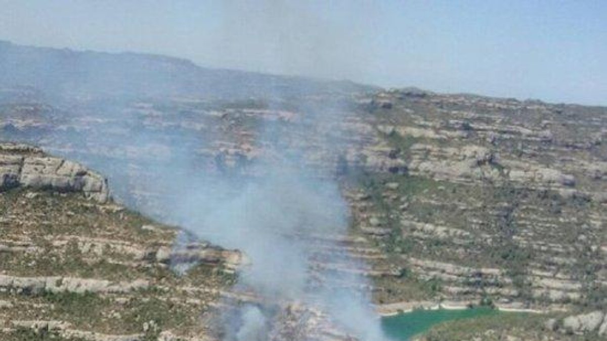 Un incendio forestal quema junto al pantano de Margalef, en la sierra del Montsant