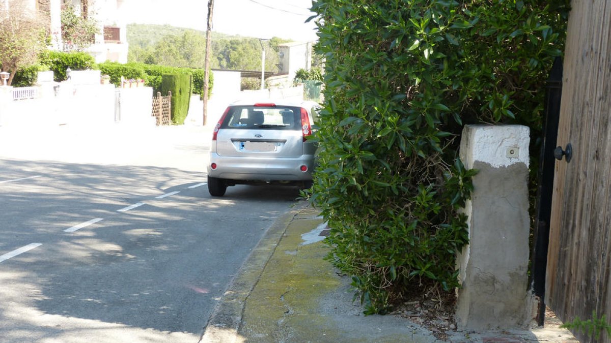 Una valla verde que invade el espacio público y dificulta el paso de las personas en el municipio.