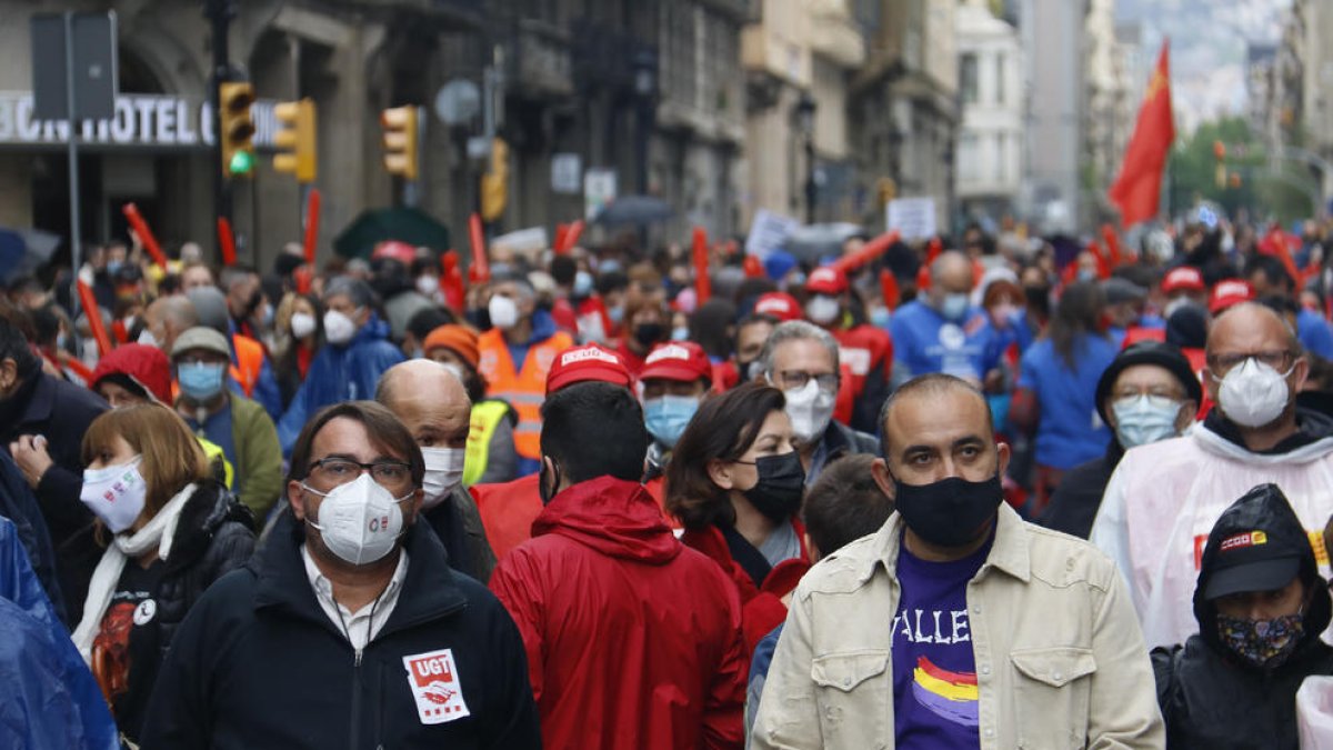 Los secretarios generales de CCOO y UGT en la manifestación de 2021.