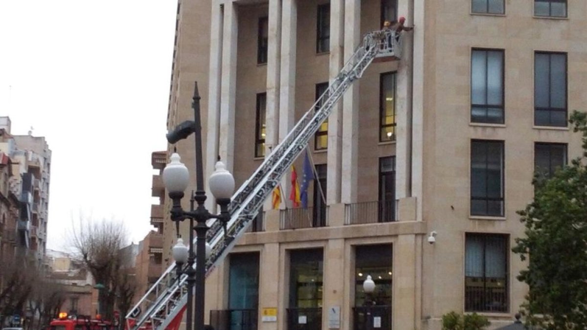 Una dotació de bombers ha 'sanejat' la façana de l'edifici d'hisenda.