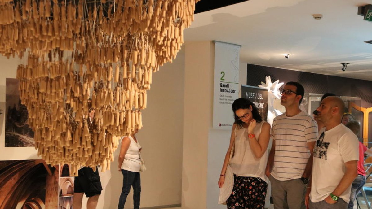 Uns visitants observen la maqueta funicular al Gaudí Centre. Imatge del 25 de juny de 2017