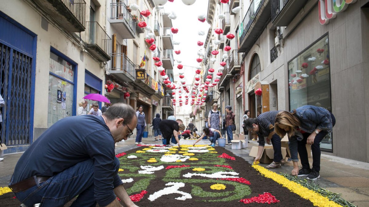 L'acte tradicional de crear catifes amb flors s'ha fet tot i la pluja