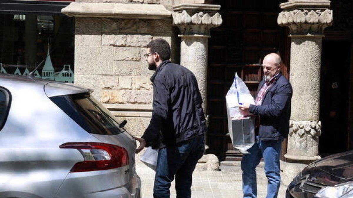 Agentes de la Guardia Civil esperan para cargar el material intervenido en el registro del Diplocat.