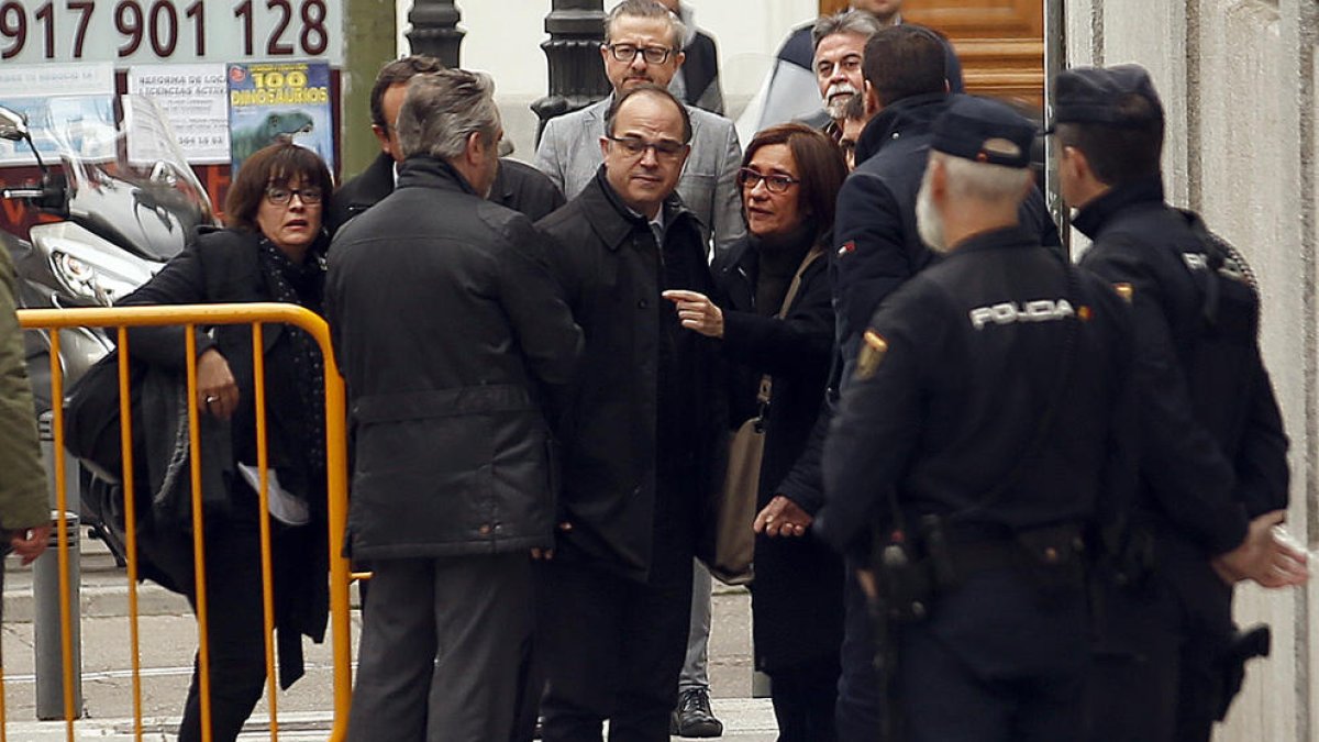 Els diputats de Junts per Catalunya Josep Rull i Jordi Turull amb les seves dones instants abans d'entrar a la seu del Tribunal Suprem.