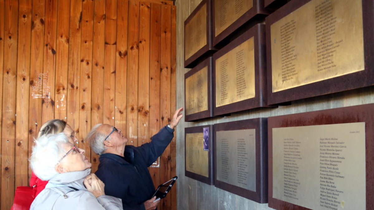 Imatge de Jean René, amb alguns familiars, buscant el nom del seu pare, Glaussel René, mort en la Batalla de l'Ebre, a les plaques d'homenatge a les víctimes