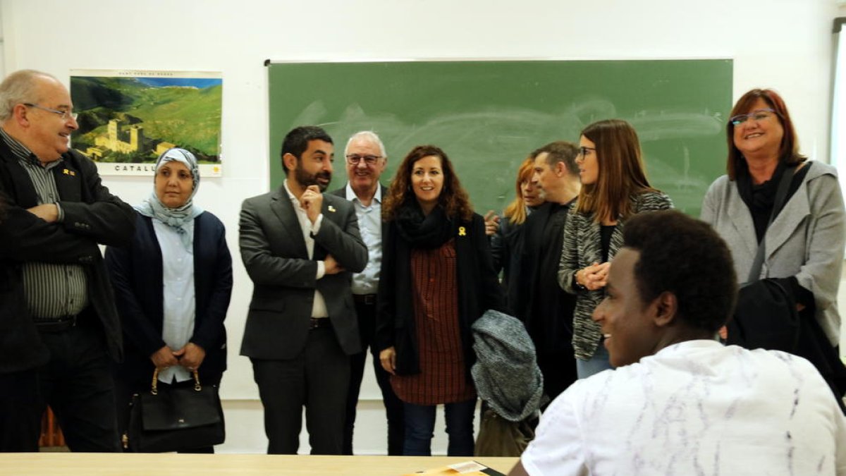 Els consellers d'Ensenyament i de Treball, Afers Socials i Famílies, Josep Bargalló i Chakir el Homrani, en una visita per un pla pilot a Tarragona, amb un jove africà assegut a primera fila.