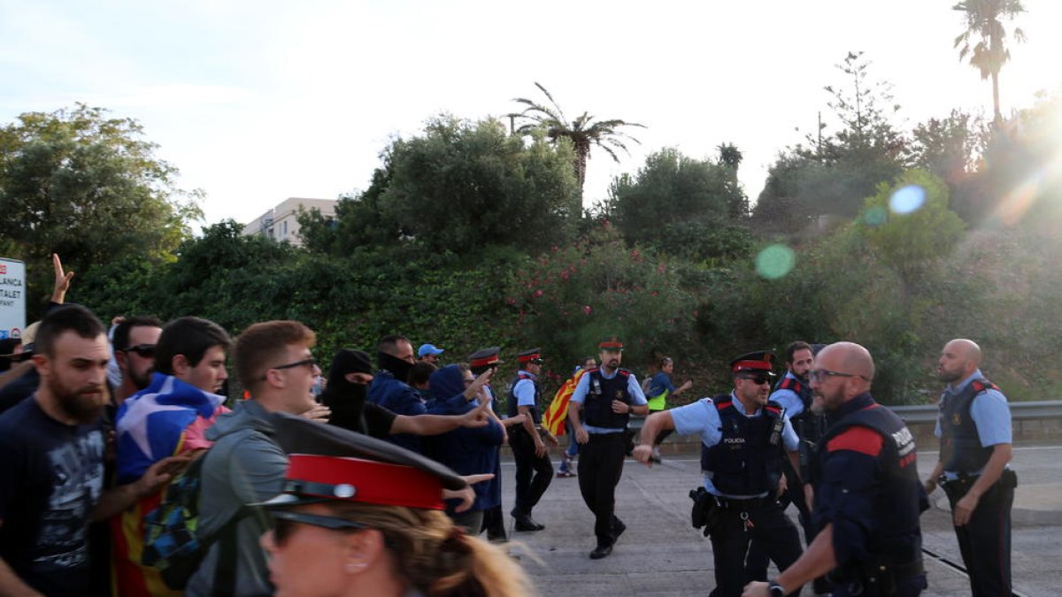 Pla general del moment d'enfrontament dels manifestants amb els agents i antidisturbis dels Mossos a l'entrada del peatge de l'Ampolla. Imatge del 18 d'octubre del 2019 (horitzontal)