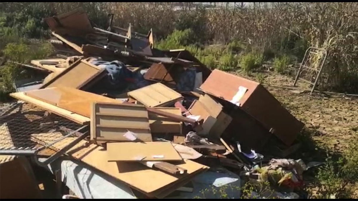 Captura del vídeo on es mostren els mobles llençats al costat del riu.